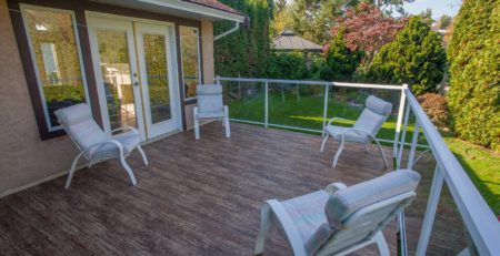 Backyard deck with 4 deck chairs - newly waterproofed with outdoor vinyl deck flooring