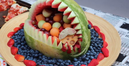 Pumkin on a fruit platter carved like an open shark's mouth