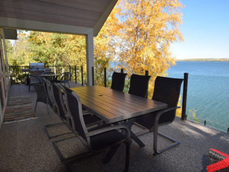 Newly finished lakefront vinyl decking with deck furniture and babecue