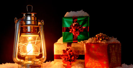 Lantern and Christmas gifts sitting in snow