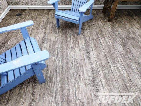 2 blue wooden lawn chairs on a newly covered vinyl wood plank deck