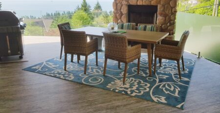 Outdoor waterproof porch flooring on a deck with a fireplace