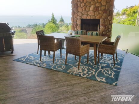 Outdoor waterproof porch flooring on a deck with a fireplace